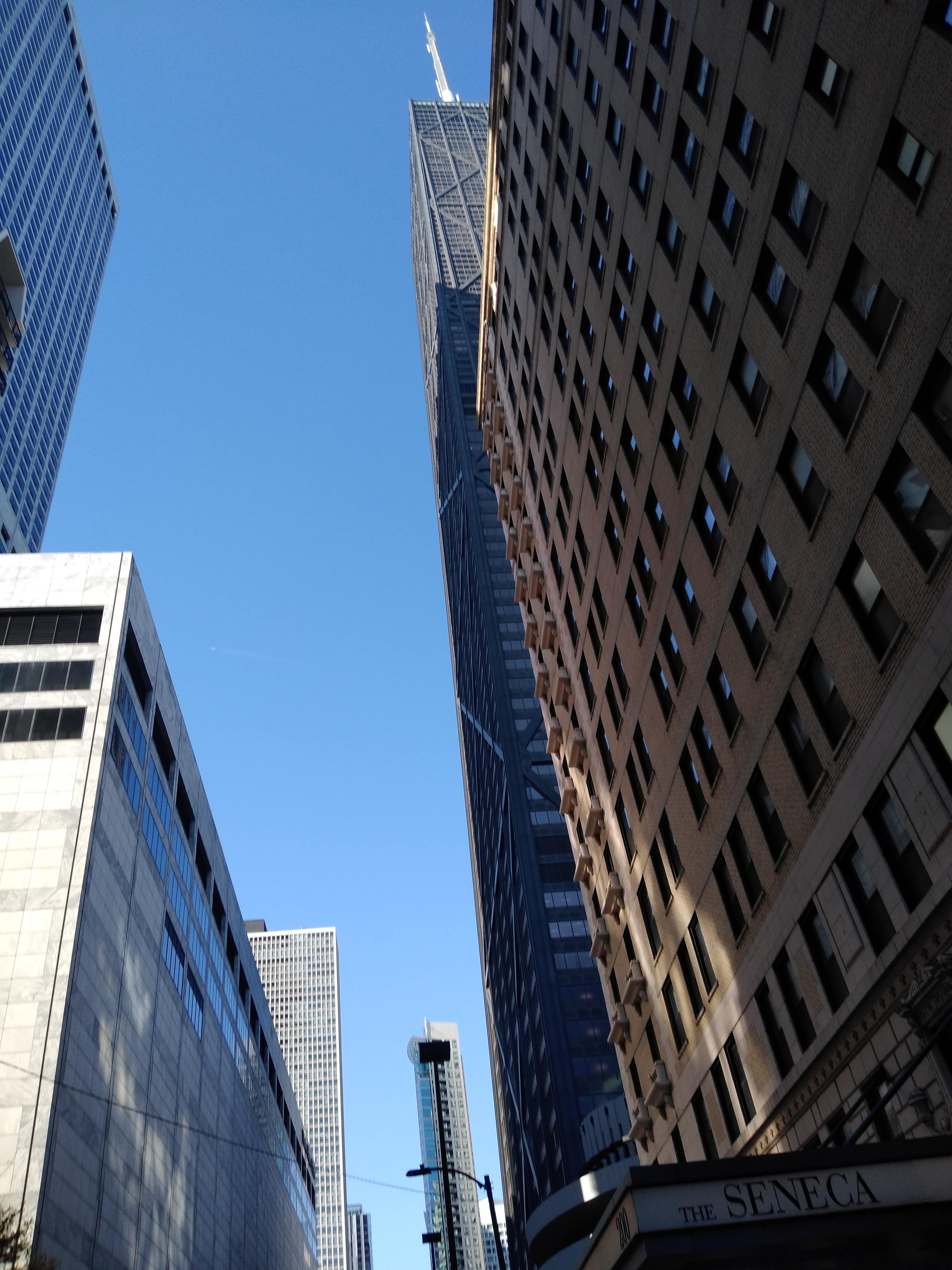 a photo taken above the viewers perspective, sky scrapers standing tall ahead.